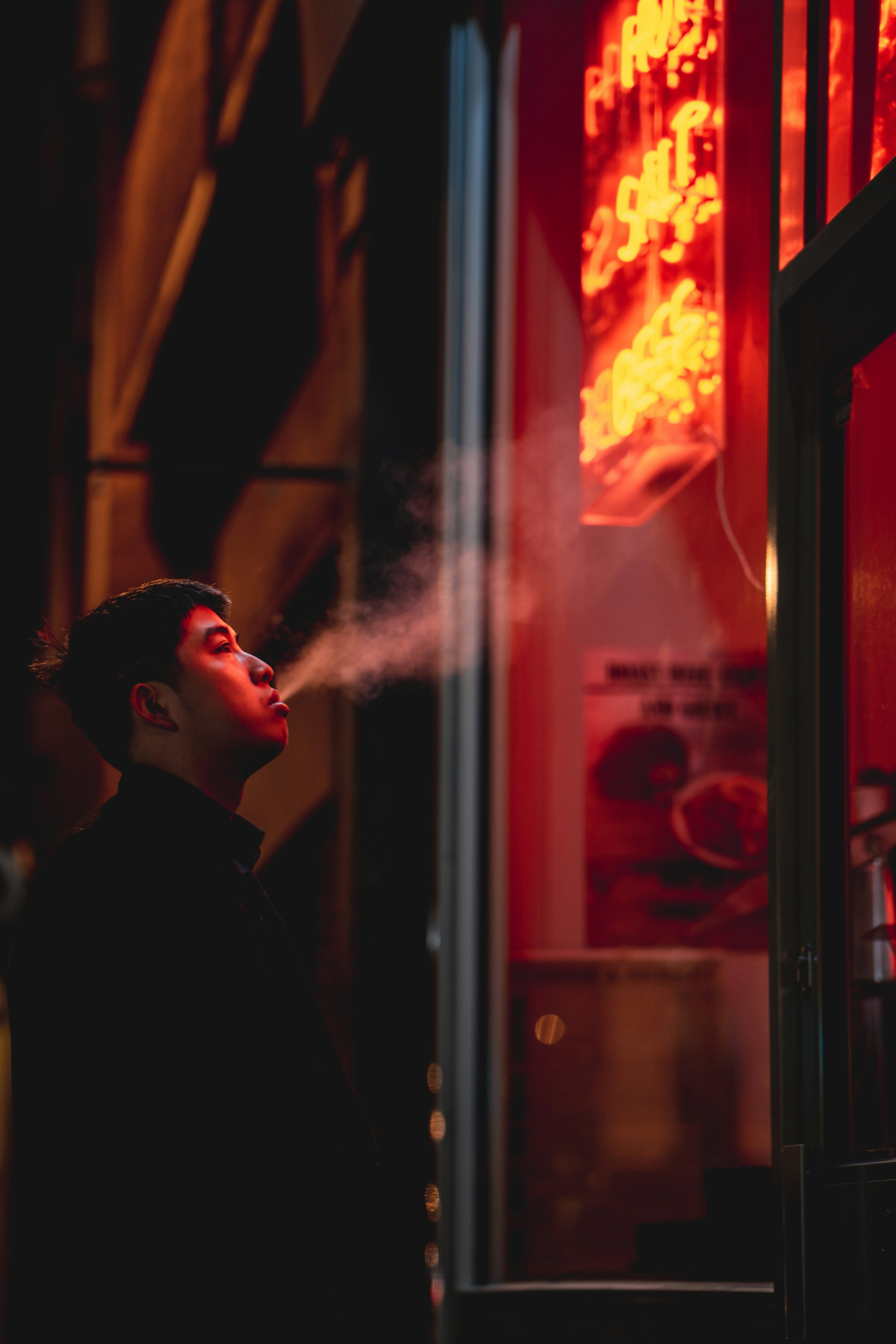 woman in black shirt standing near glass window